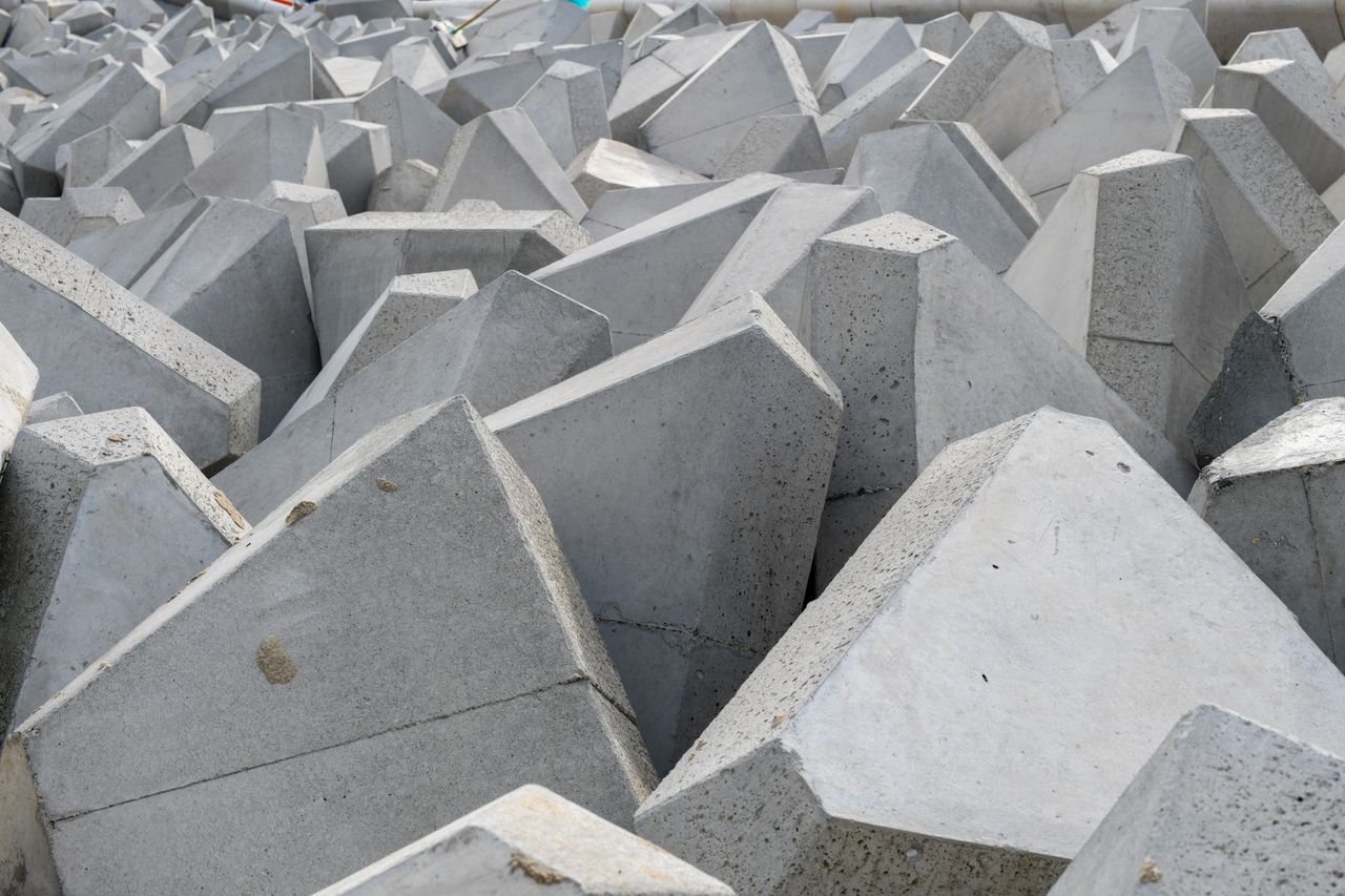 Rugged concrete dolosse safeguarding the seashore from erosion.