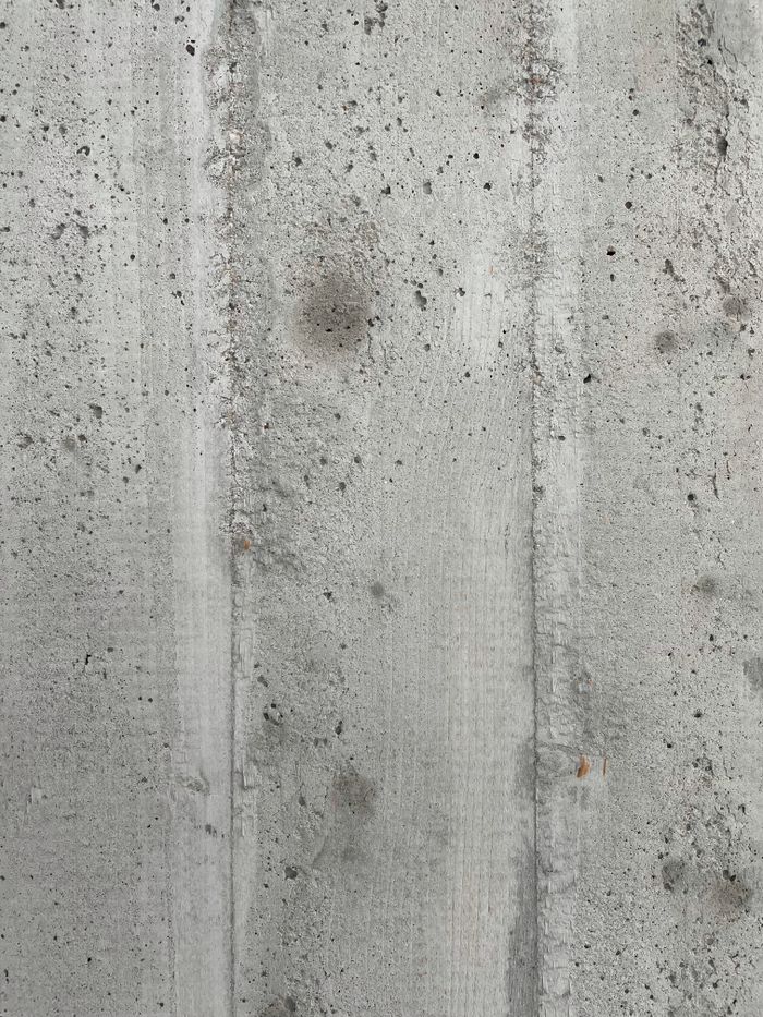 Detailed shot of a rough concrete wall texture, ideal for backgrounds.